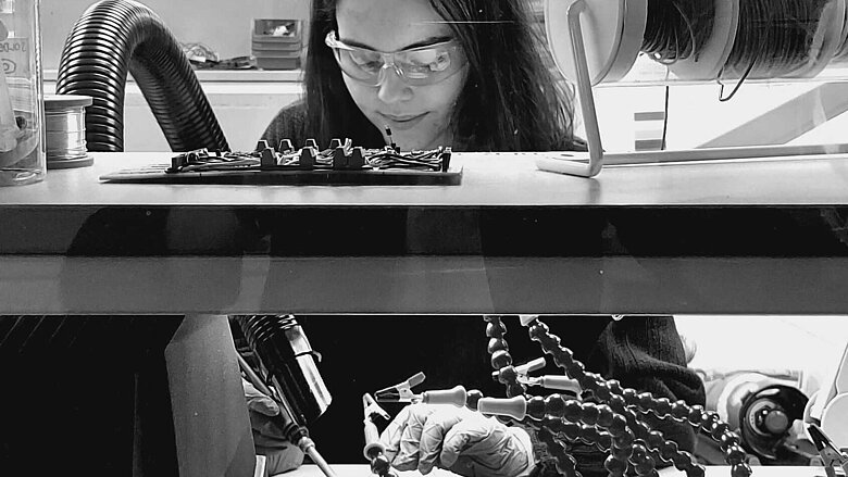 Female engineer Holly Withnell working at Caeli Nova laboratory.